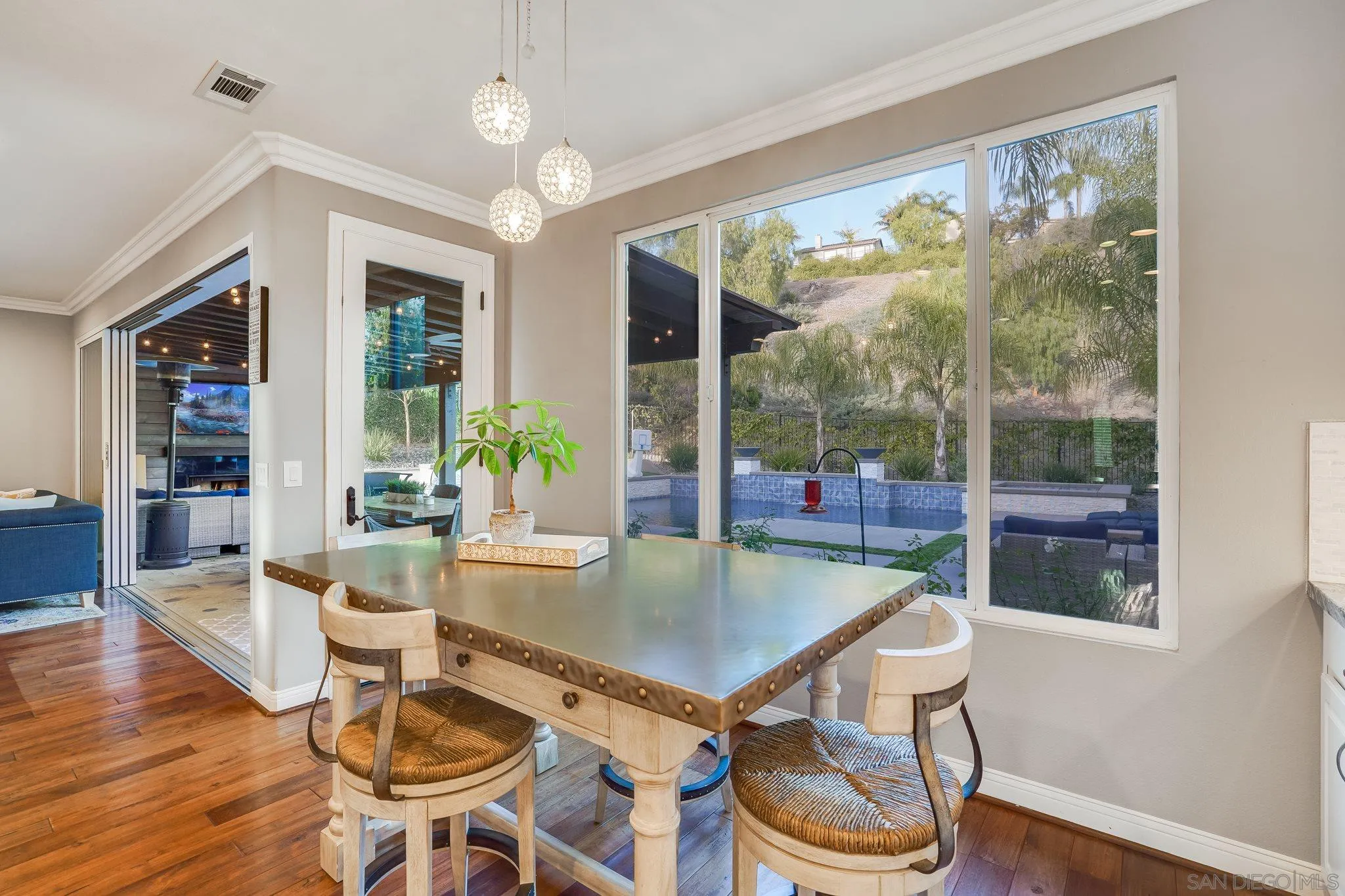 16375 Cayenne Ridge Road San Diego, CA 92127 - Photo 12 of 35 a dining room with wooden floor a glass table and chairs