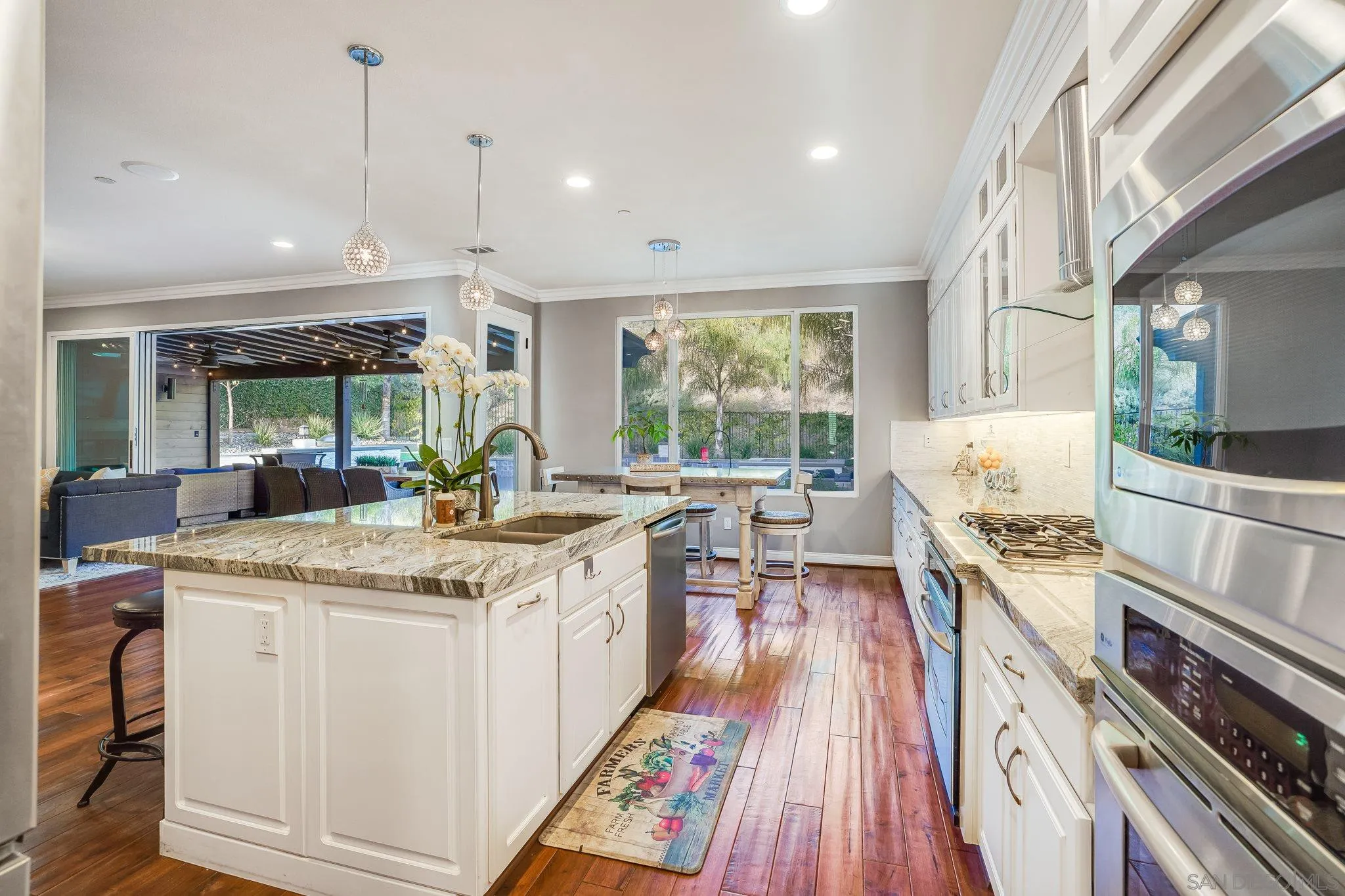16375 Cayenne Ridge Road San Diego, CA 92127 - Photo 15 of 35 a open kitchen with stainless steel appliances granite countertop a stove and cabinets