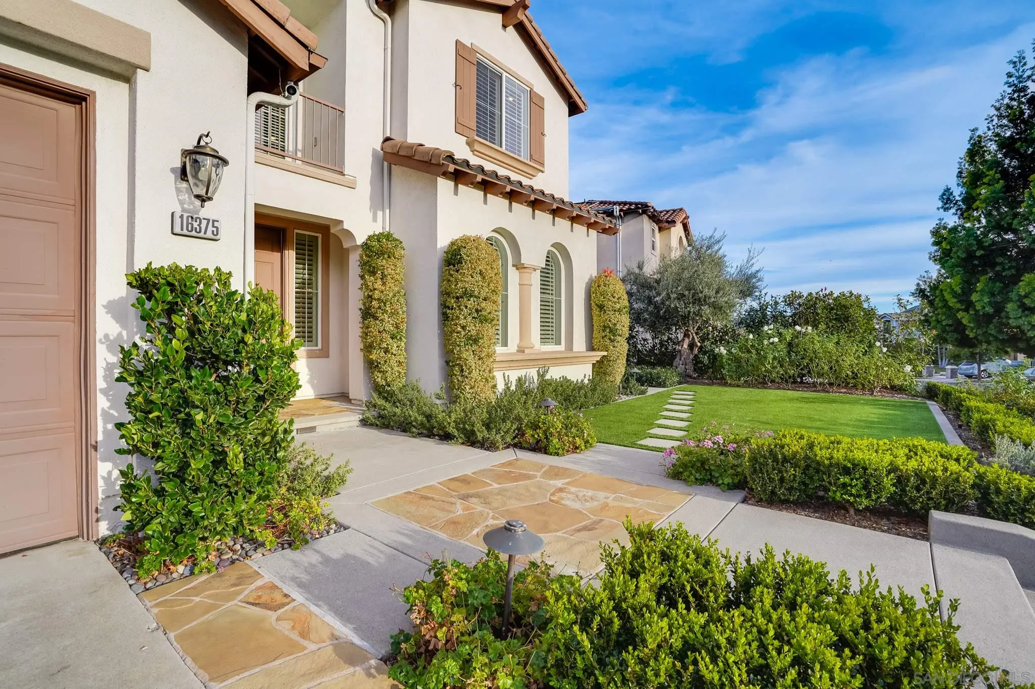 16375 Cayenne Ridge Road San Diego, CA 92127 - Photo 3 of 35 a front view of a house with garden and trees