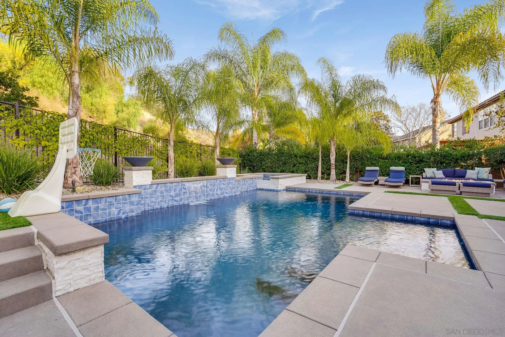 16375 Cayenne Ridge Road San Diego, CA 92127 - Photo 34 of 35 a view of swimming pool that has lawn chairs with plants and palm trees