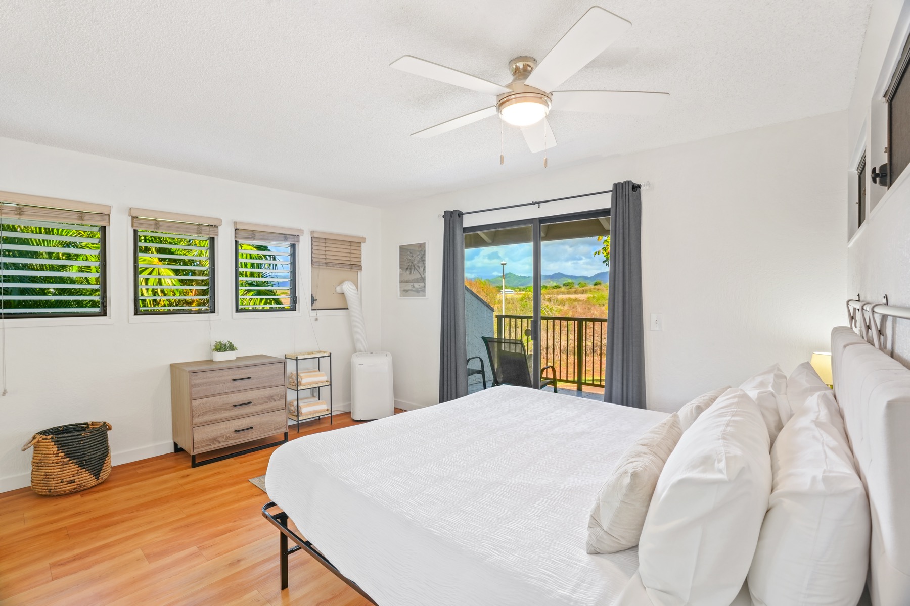 1901 Poipu Road, Unit 924 Koloa, HI 96756 - Photo 9 of 27 a bedroom with a bed and a chandelier