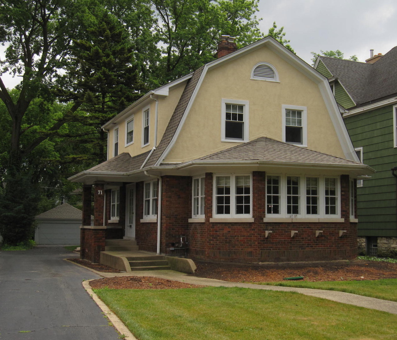 71 North Cowley Road Riverside, IL 60546 - Photo 1 of 23 a view of a white house with large windows and a yard with plants and large trees