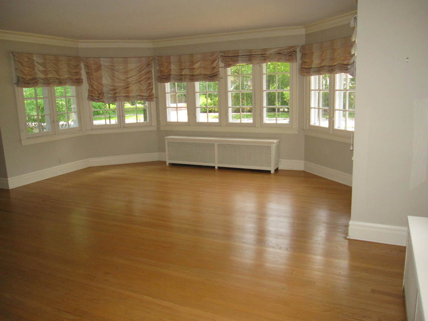 71 North Cowley Road Riverside, IL 60546 - Photo 3 of 23 a view of an empty room with a window and wooden floor