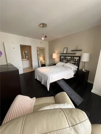 a dining hall with stainless steel appliances kitchen island granite countertop a dining table and chairs