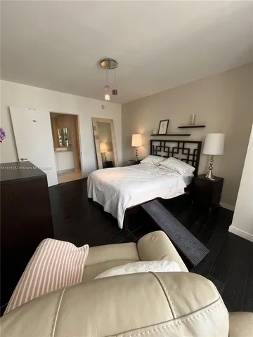 a dining hall with stainless steel appliances kitchen island granite countertop a dining table and chairs