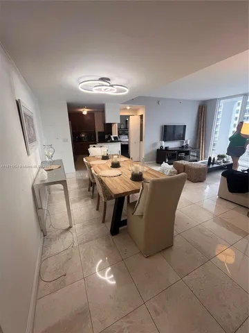 a room with a sink a table and chairs