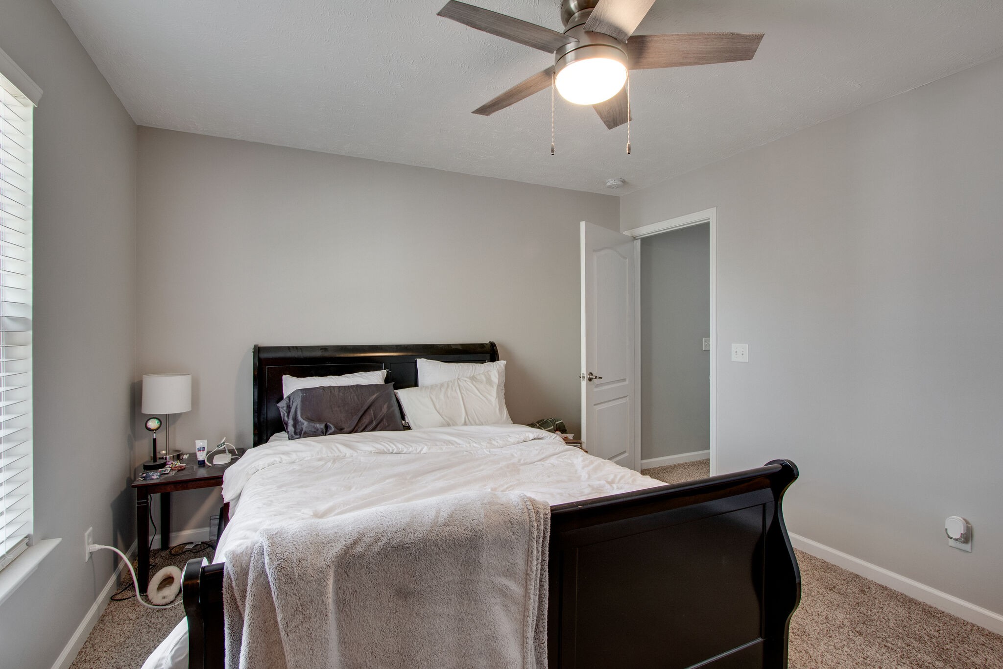 284 Meigs Drive, Unit D24 Murfreesboro, TN 37128 - Photo 14 of 16 a bedroom with a bed and a chandelier