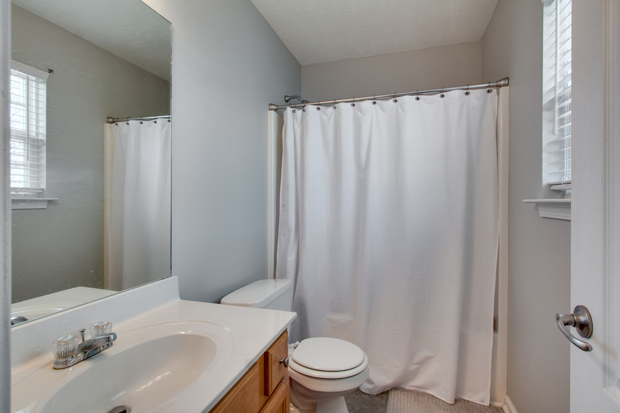 284 Meigs Drive, Unit D24 Murfreesboro, TN 37128 - Photo 15 of 16 a bathroom with a sink a toilet and shower