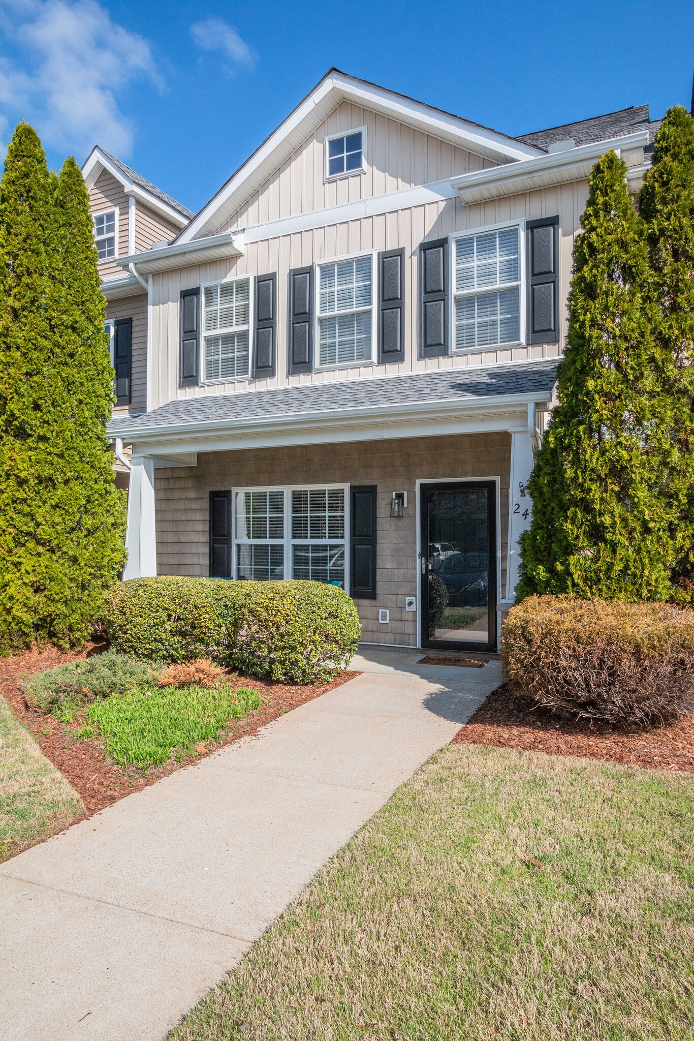 284 Meigs Drive, Unit D24 Murfreesboro, TN 37128 - Photo 2 of 16 a front view of a house with a yard and garage