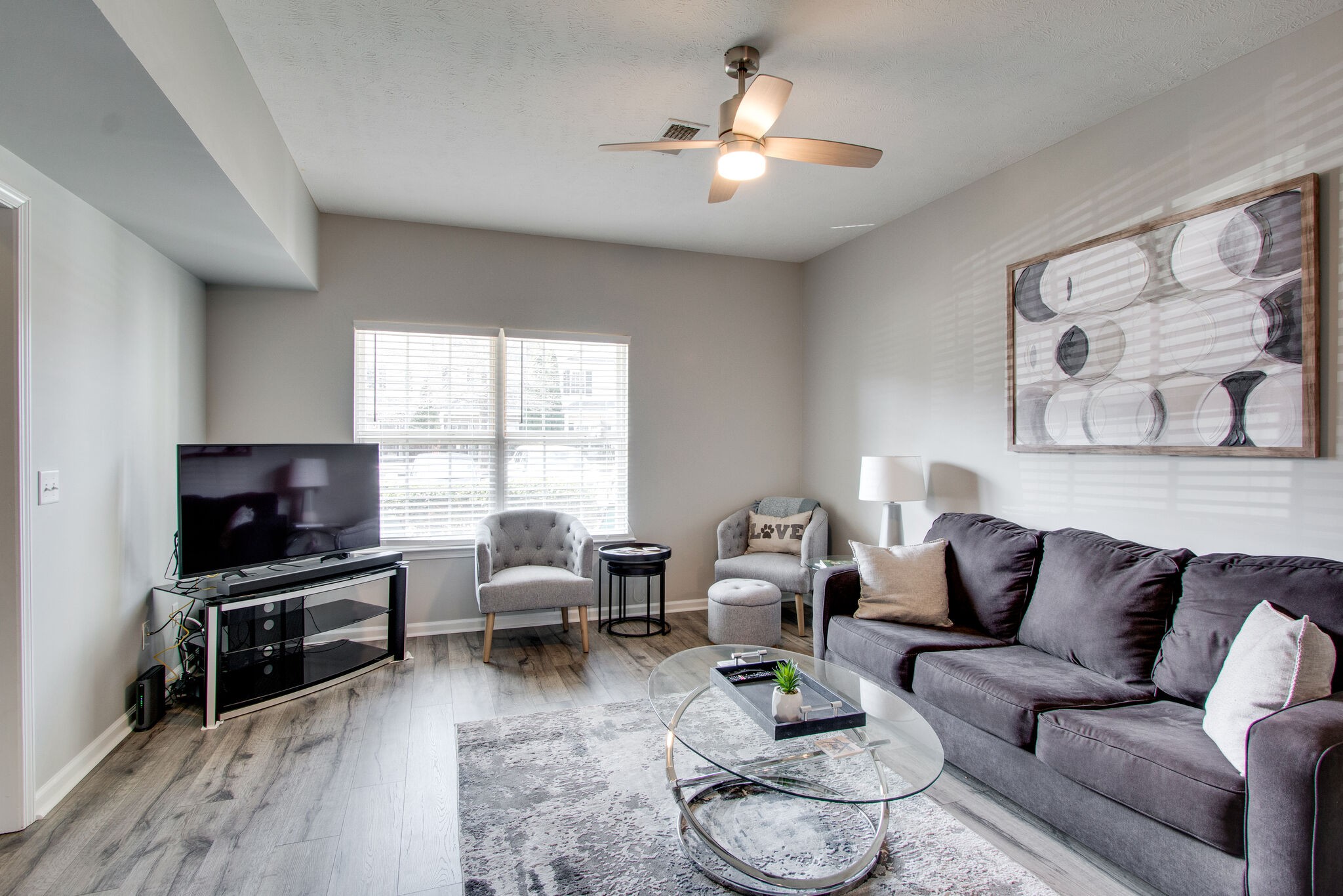 284 Meigs Drive, Unit D24 Murfreesboro, TN 37128 - Photo 4 of 16 a living room with furniture a chandelier and a flat screen tv