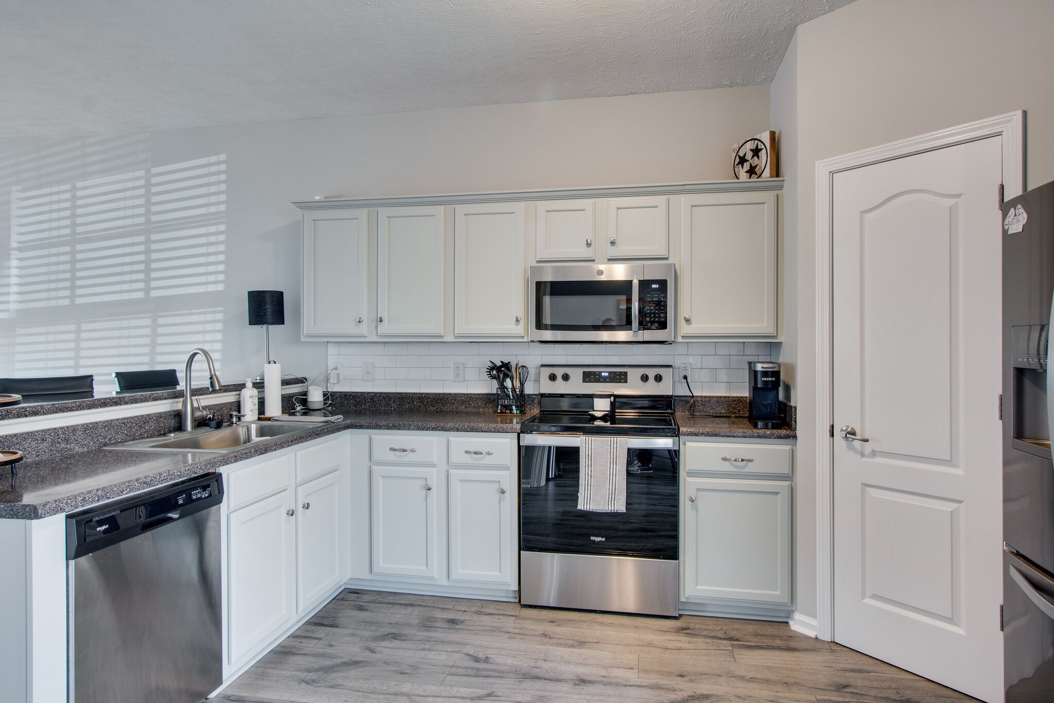 284 Meigs Drive, Unit D24 Murfreesboro, TN 37128 - Photo 7 of 16 a kitchen with white cabinets appliances and sink