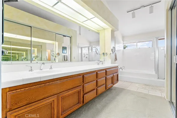 a spacious bathroom with double sink and a large mirror