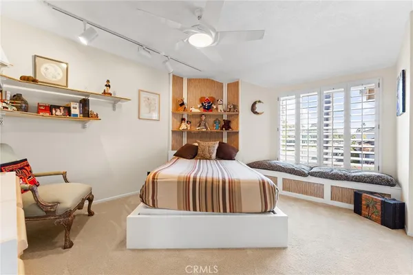 a bedroom with a bed and a large window