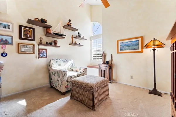 a living room with furniture and wall paintings