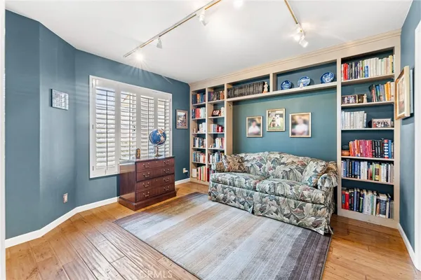 a bedroom with furniture and a book shelf
