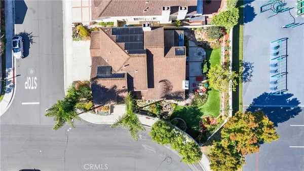 an aerial view of a house with a garden and mountain view