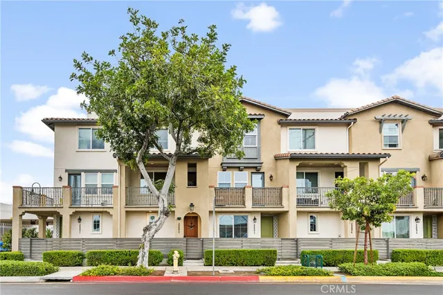 a front view of residential houses with yard and green space