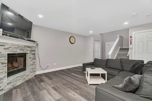 a view of a livingroom with a fireplace and a window