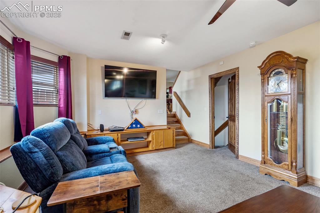 18895 Sage Crest Road Peyton, CO 80831 - Photo 21 of 38 a living room with furniture and a flat screen tv