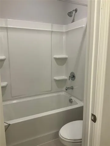 a bathroom with a bathtub and a toilet