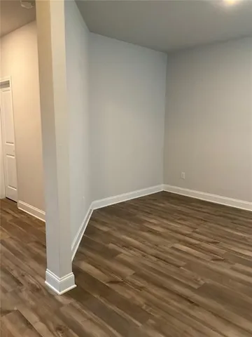 a view of wooden floor and windows in a room