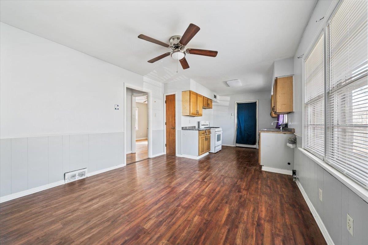 1821 Dale Lavern Road Memphis, TN 38116 - Photo 16 of 21 a view of a kitchen with wooden floor a ceiling fan and windows