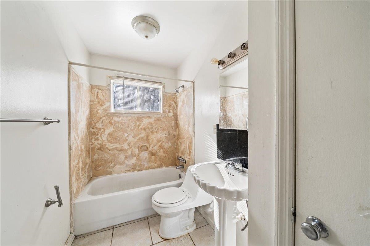 1821 Dale Lavern Road Memphis, TN 38116 - Photo 18 of 21 a bathroom with a bathtub shower sink mirror and toilet