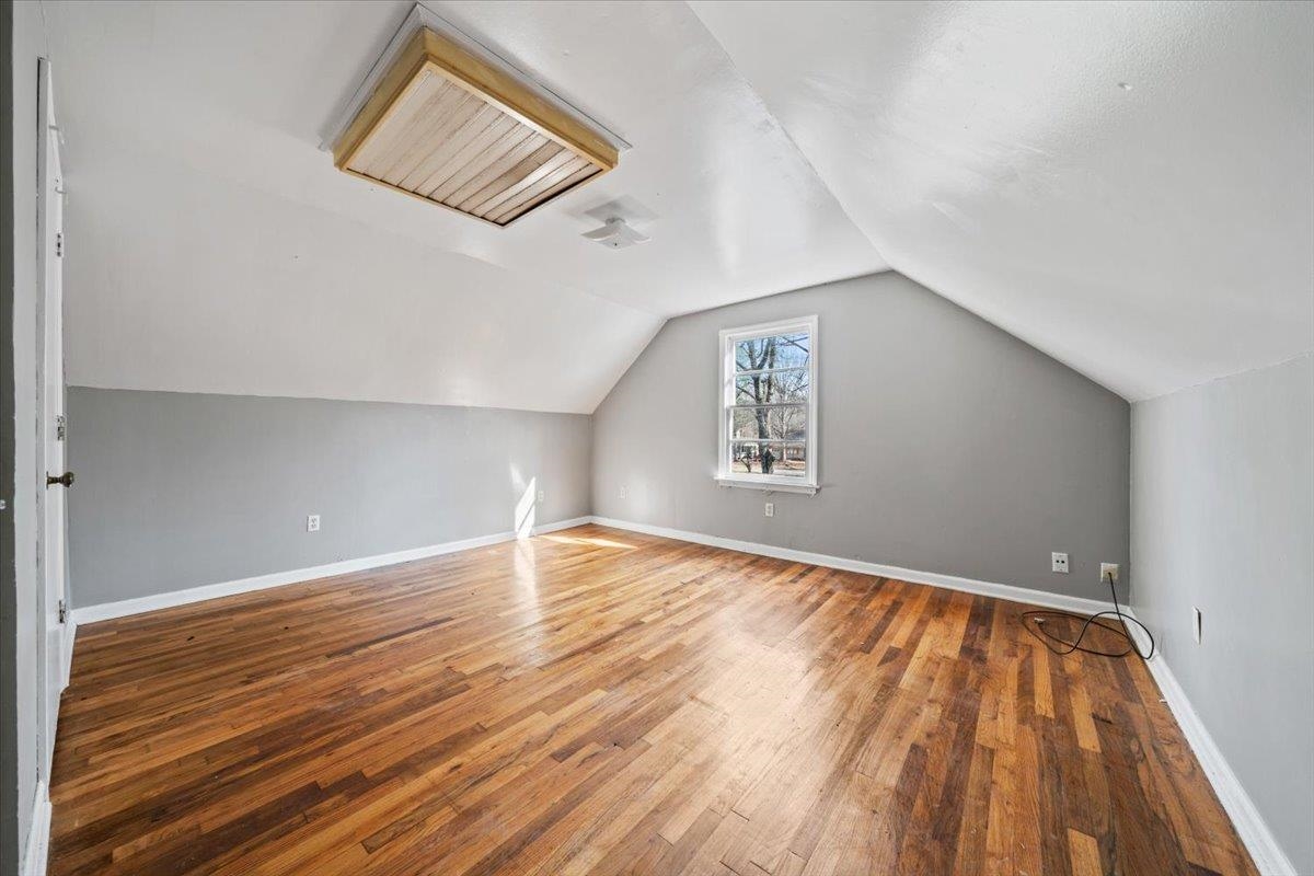 1821 Dale Lavern Road Memphis, TN 38116 - Photo 6 of 21 an empty room with wooden floor and windows