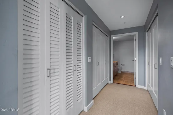 a view of hallway with a bathroom