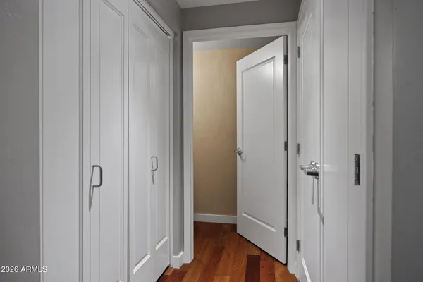 a view of a hallway with wooden floor