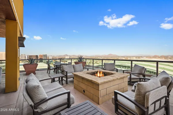 a living room with patio furniture and a large window