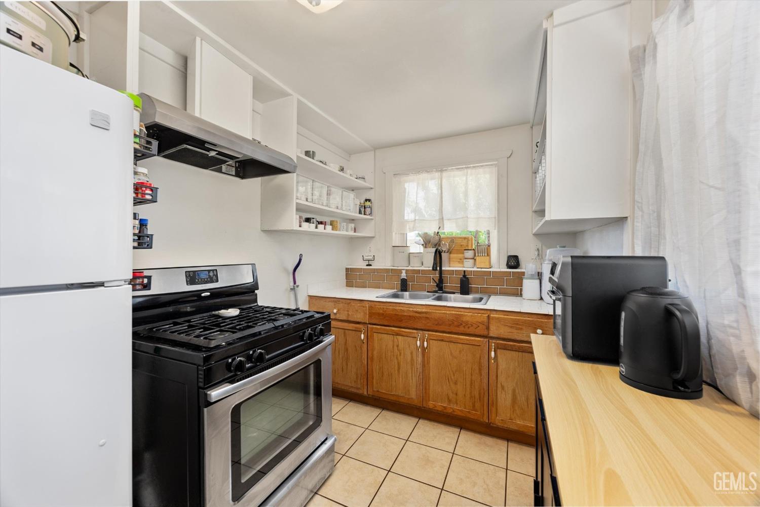 Undisclosed Address Bakersfield, CA 93304 - Photo 15 of 25 a kitchen with stainless steel appliances granite countertop a stove a sink dishwasher and a refrigerator