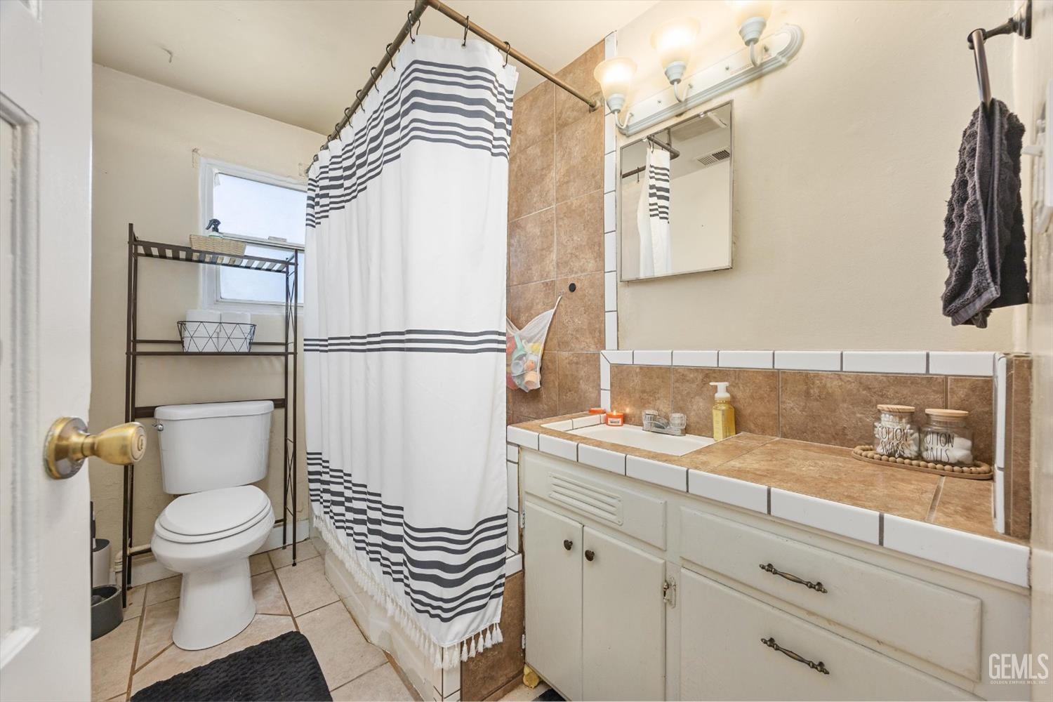 Undisclosed Address Bakersfield, CA 93304 - Photo 20 of 25 a bathroom with a sink toilet and shower