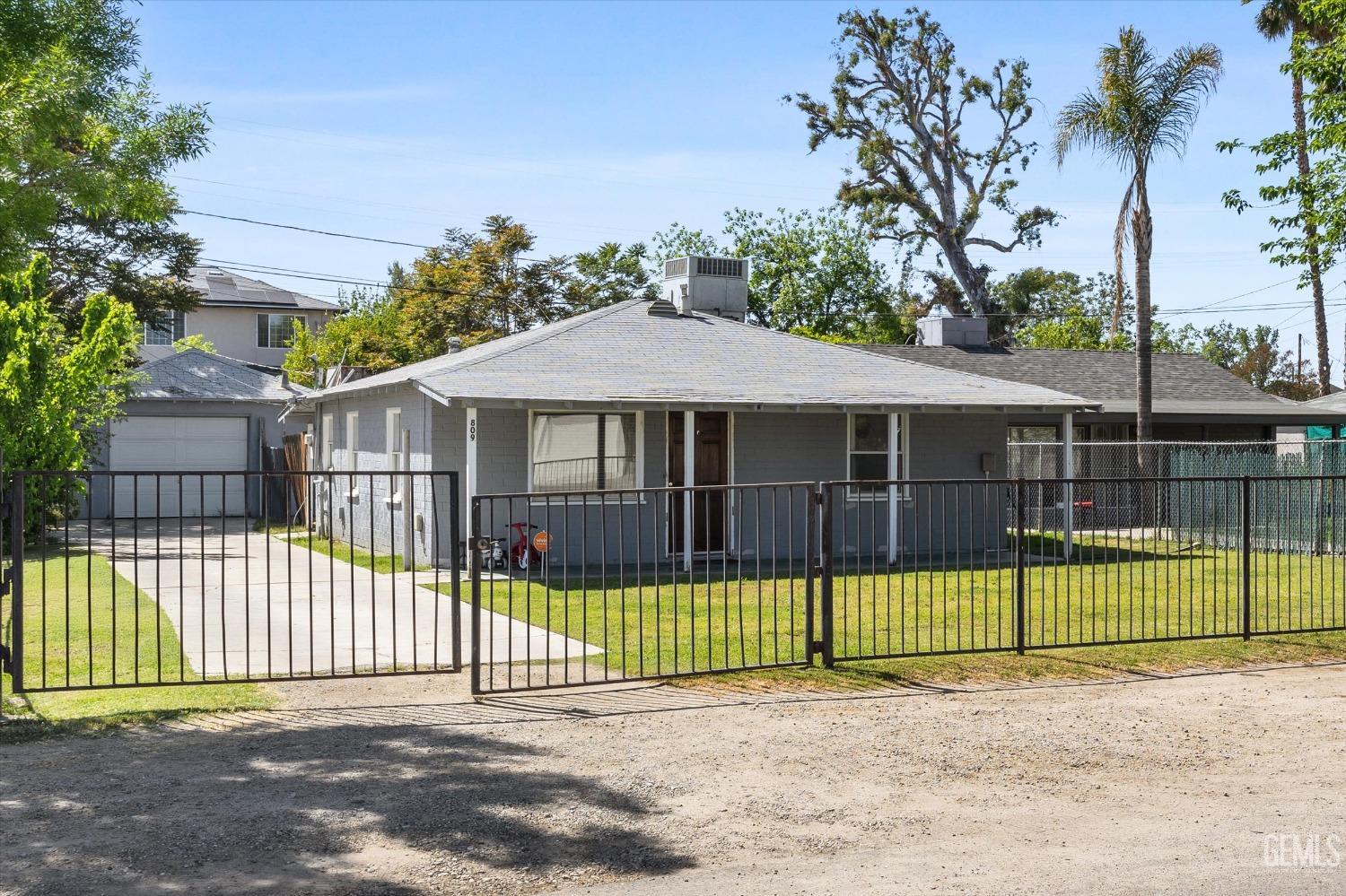 Undisclosed Address Bakersfield, CA 93304 - Photo 2 of 25 a view of a backyard with a small garden