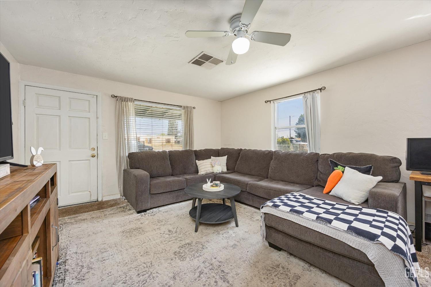 Undisclosed Address Bakersfield, CA 93304 - Photo 8 of 25 a bedroom with a large bed and a couch