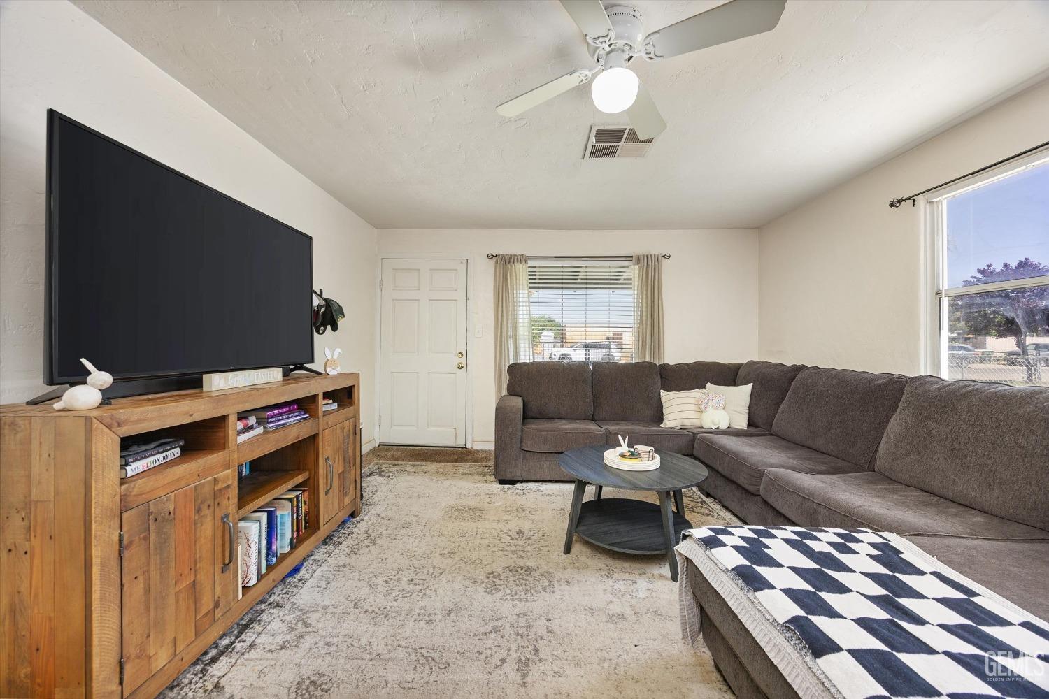 Undisclosed Address Bakersfield, CA 93304 - Photo 9 of 25 a living room with furniture and a flat screen tv