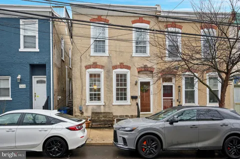 a front view of a house with parking space