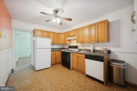 a kitchen with a refrigerator and a sink