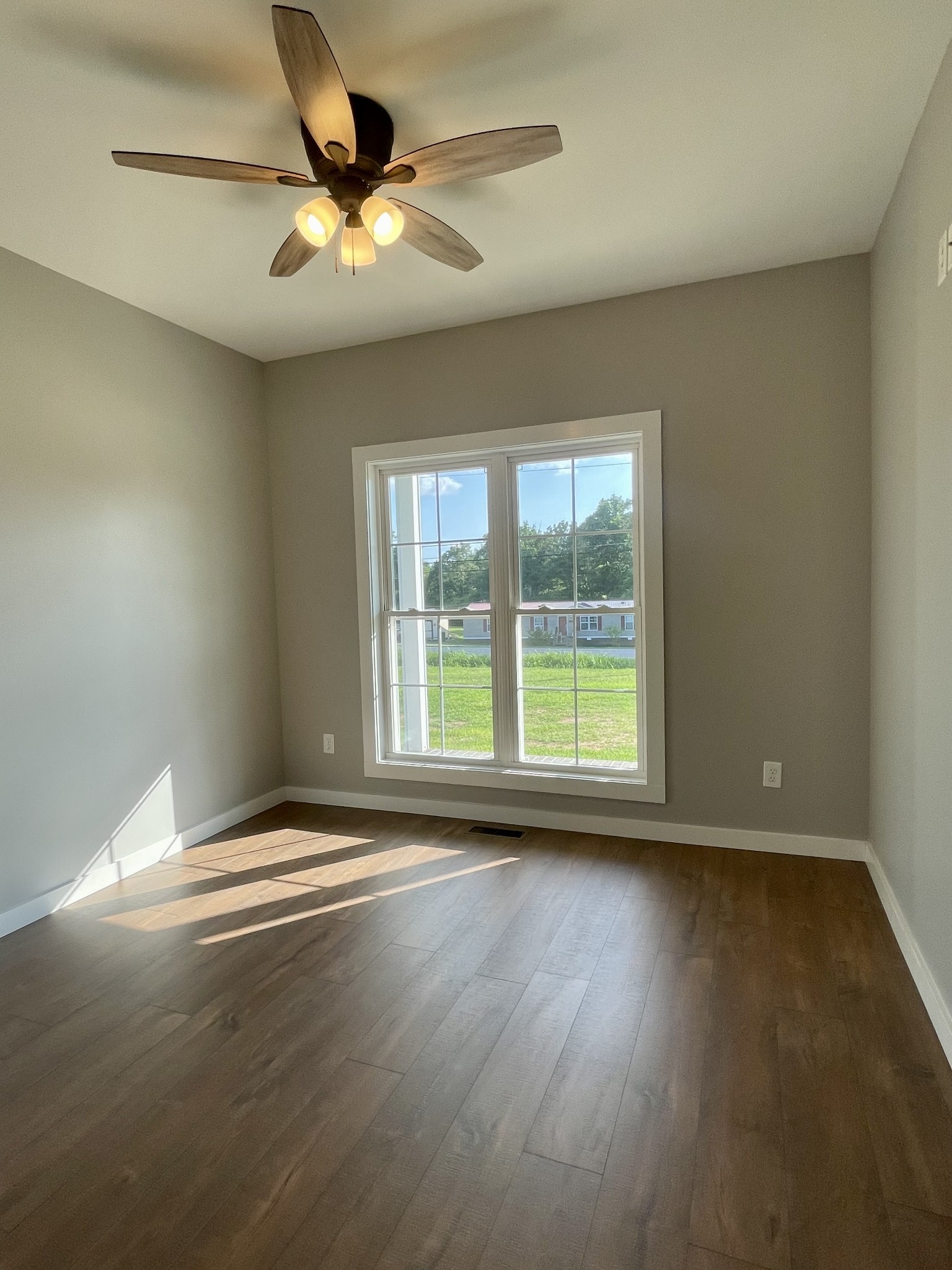 1460 Fall River Road Lawrenceburg, TN 38464 - Photo 11 of 31 a view of an empty room with wooden floor and a window