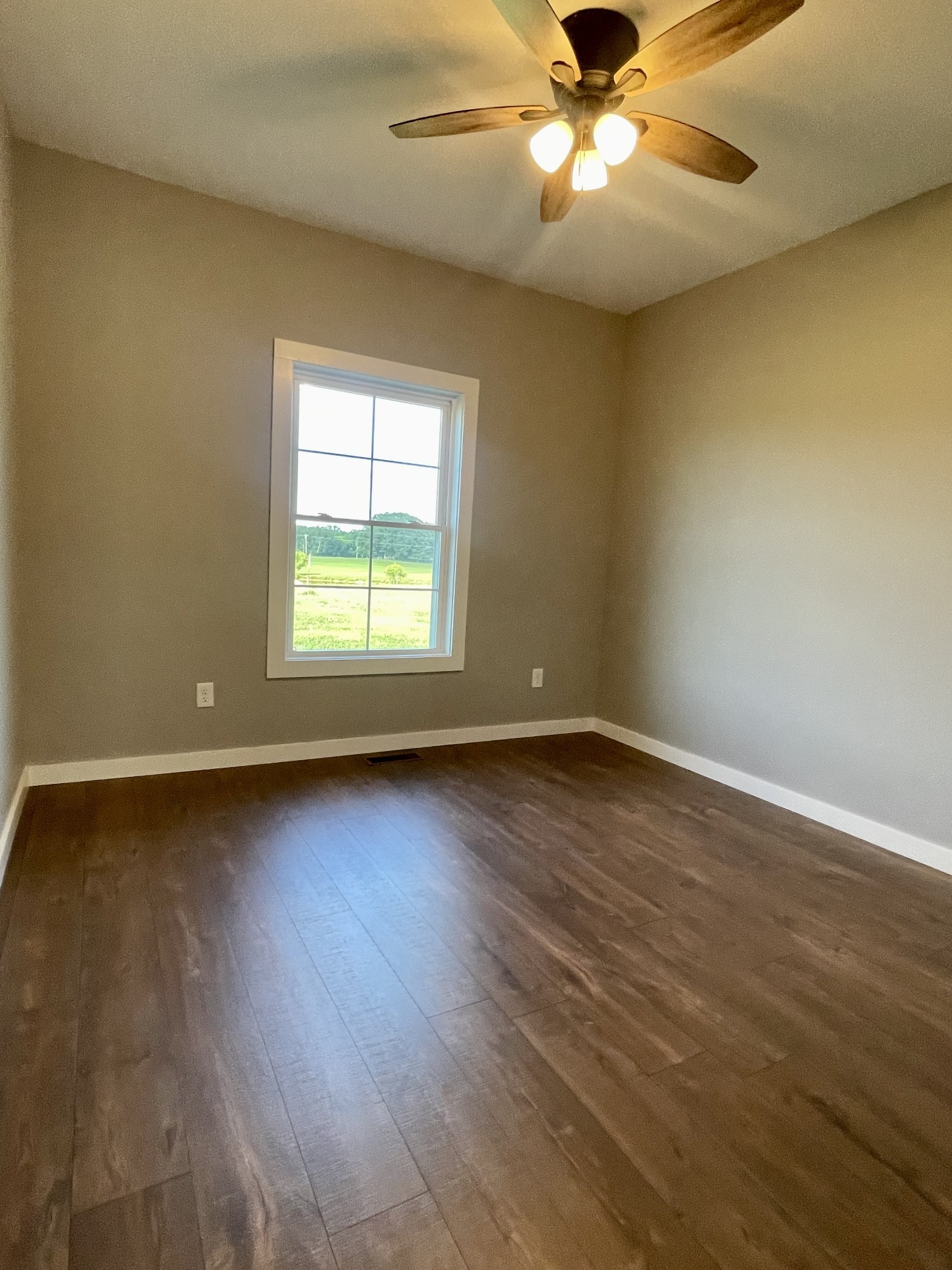 1460 Fall River Road Lawrenceburg, TN 38464 - Photo 18 of 31 a view of an empty room with wooden floor and a window