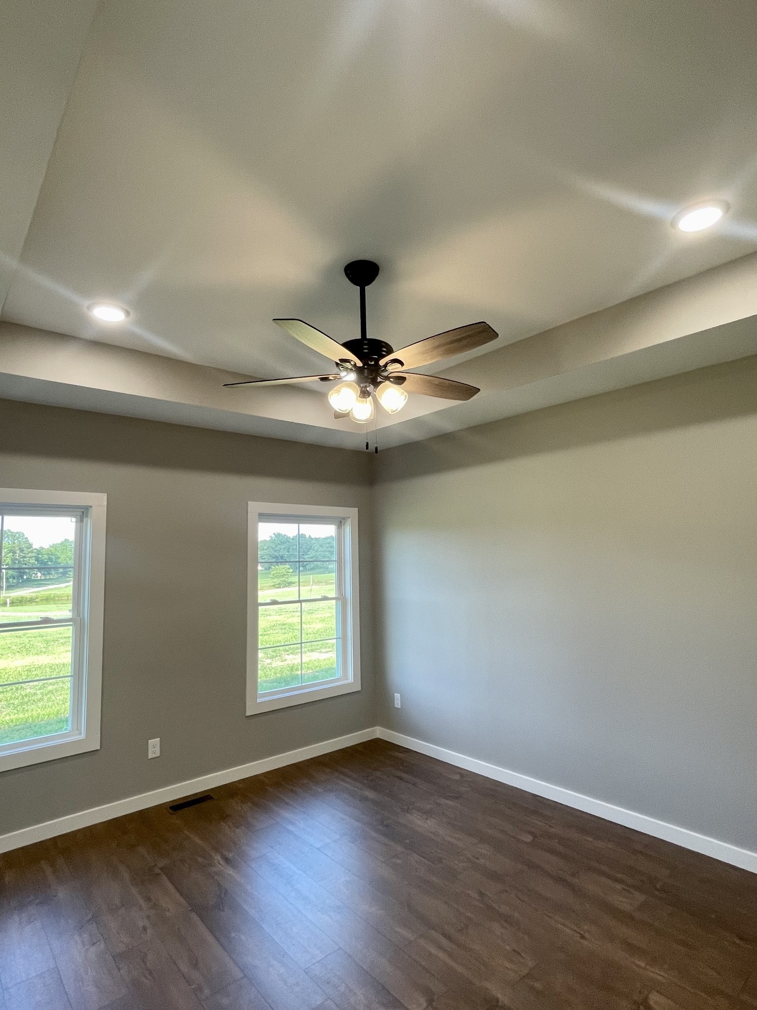 1460 Fall River Road Lawrenceburg, TN 38464 - Photo 2 of 31 an empty room with wooden floor chandelier fan and windows