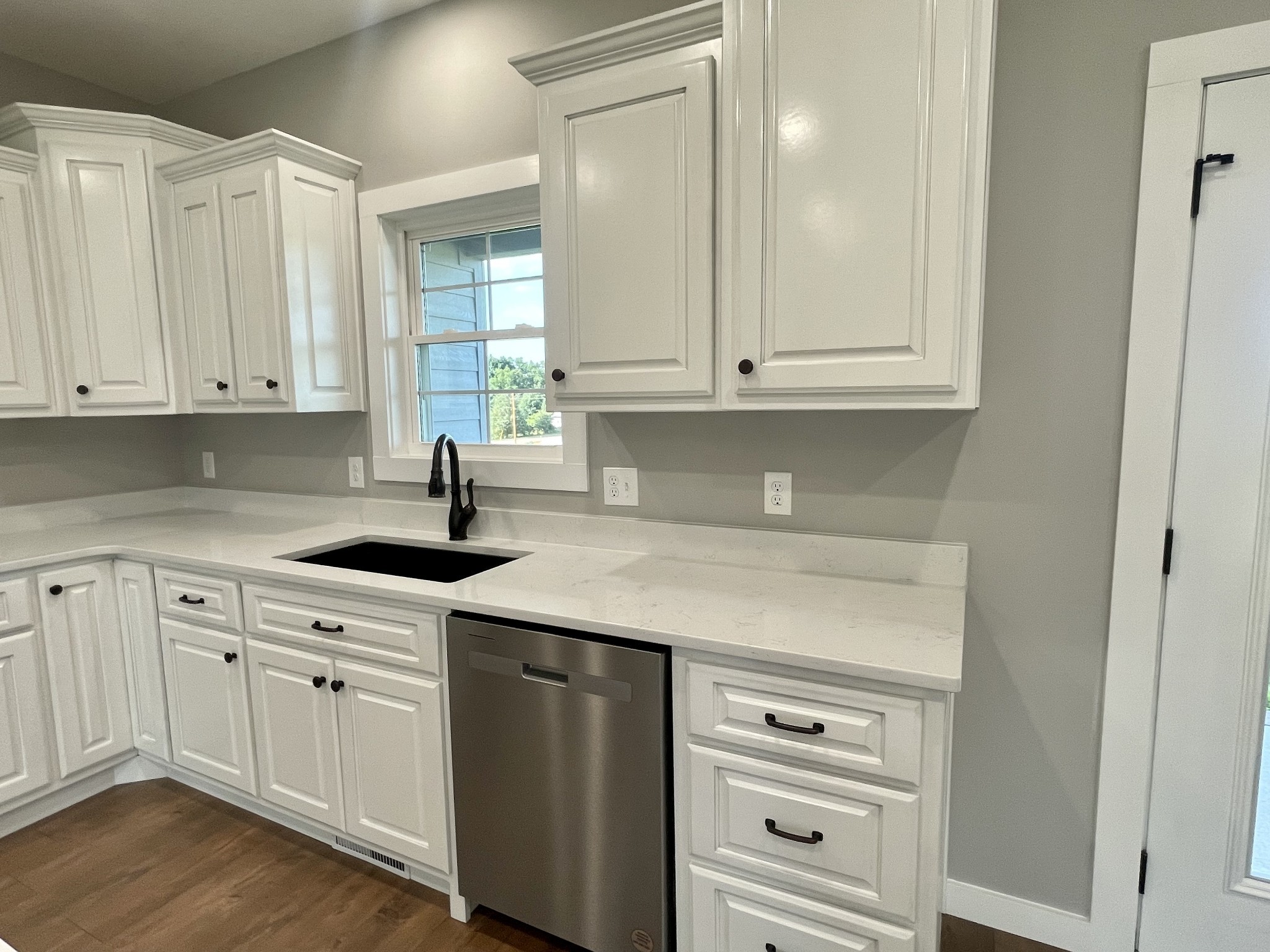 1460 Fall River Road Lawrenceburg, TN 38464 - Photo 5 of 31 a kitchen with granite countertop white cabinets and sink
