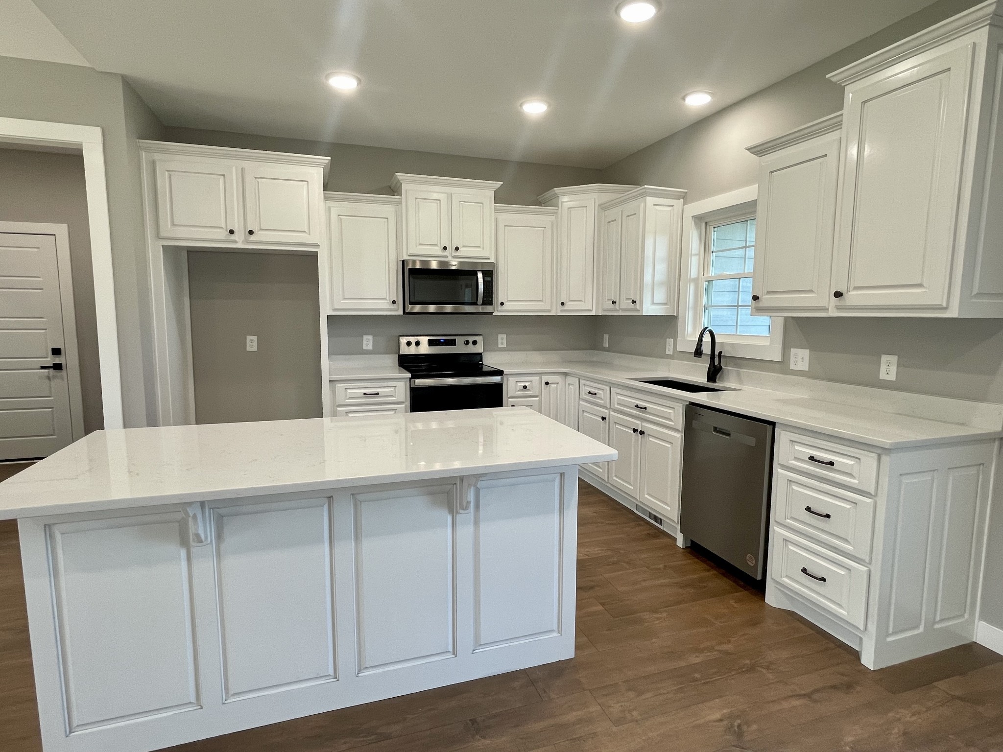 1460 Fall River Road Lawrenceburg, TN 38464 - Photo 6 of 31 a kitchen with cabinets appliances a sink and a counter top space