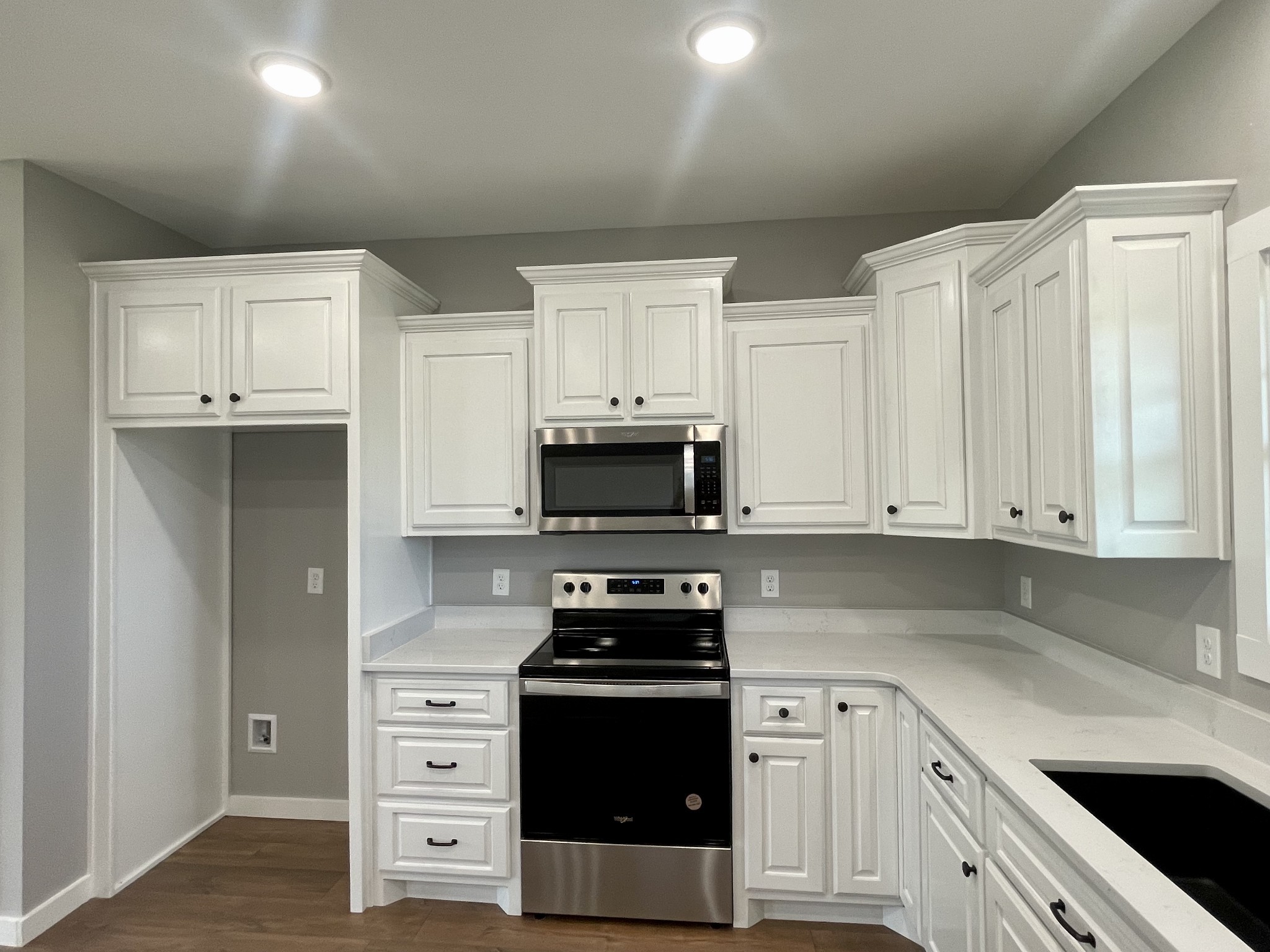 1460 Fall River Road Lawrenceburg, TN 38464 - Photo 7 of 31 a kitchen with granite countertop white cabinets and stainless steel appliances
