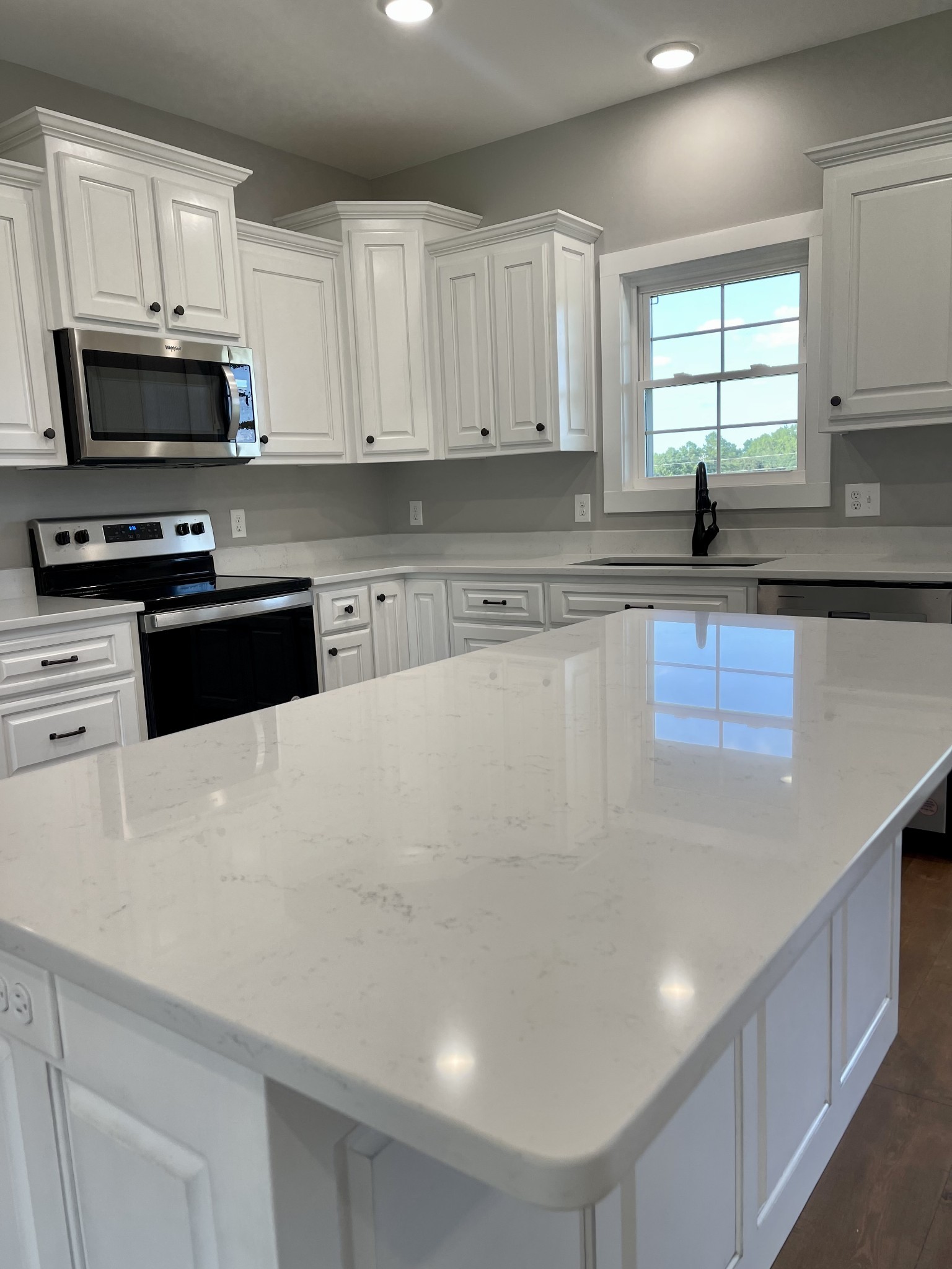1460 Fall River Road Lawrenceburg, TN 38464 - Photo 8 of 31 a kitchen with stainless steel appliances a microwave a sink and cabinets