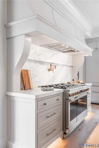 a kitchen with granite countertop a stove and a sink