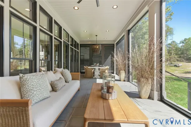 a living room with couch and large windows