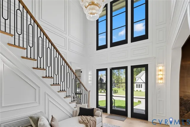 a view of staircase with lots of windows and white walls