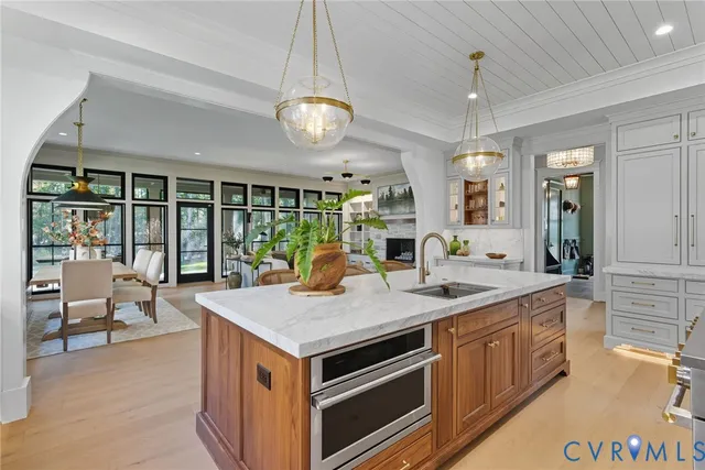 an open kitchen with a stove and a large window