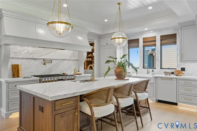 a kitchen with a table a sink and cabinets